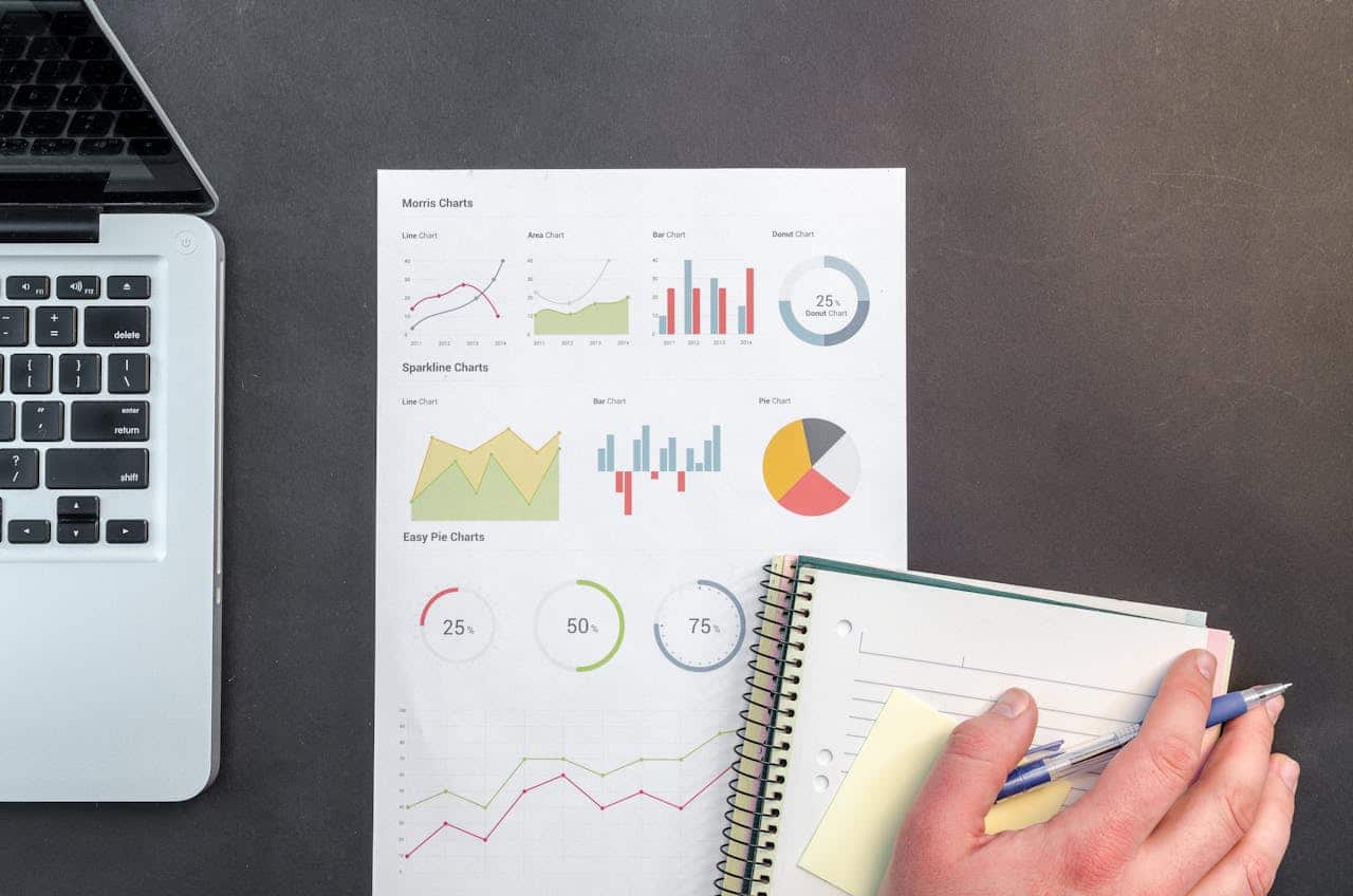 contact-img Overhead view of a business desk with charts and a laptop, ideal for data analysis concepts.